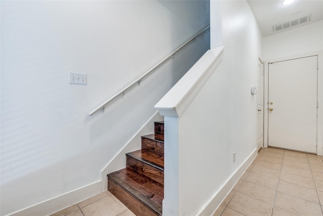 staircase with tile patterned floors