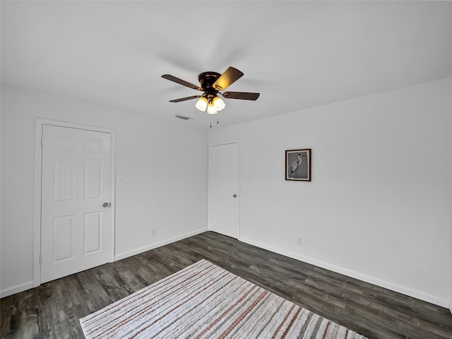 unfurnished room featuring ceiling fan and dark hardwood / wood-style floors