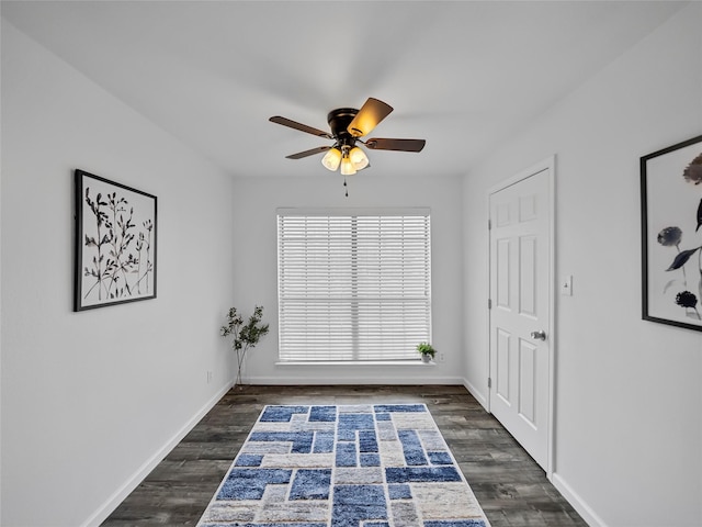 unfurnished room with ceiling fan and dark hardwood / wood-style flooring