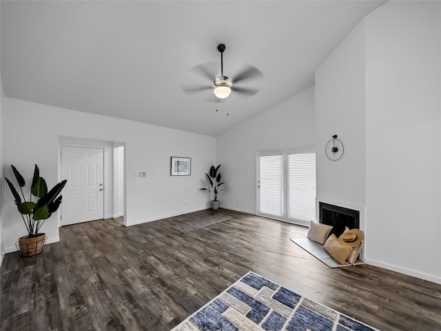 unfurnished living room with ceiling fan, dark hardwood / wood-style floors, and vaulted ceiling