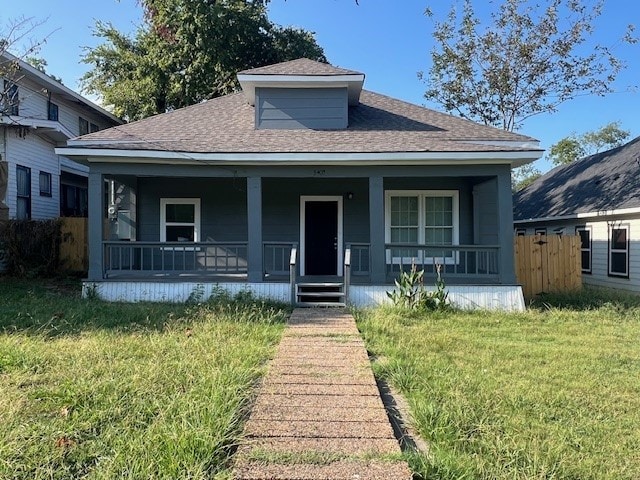 bungalow-style house featuring a porch and a front lawn