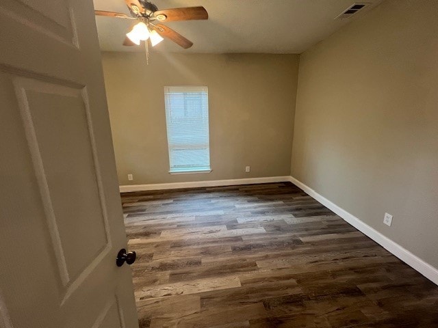 empty room featuring dark hardwood / wood-style floors and ceiling fan