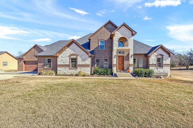 french country inspired facade featuring a garage and a front lawn