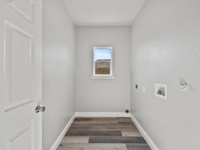 clothes washing area with dark wood-type flooring, washer hookup, and hookup for an electric dryer