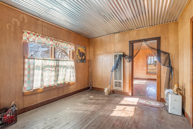 interior space featuring hardwood / wood-style flooring, a wealth of natural light, and wood walls