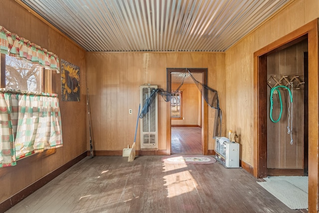 empty room featuring dark hardwood / wood-style floors and wood walls