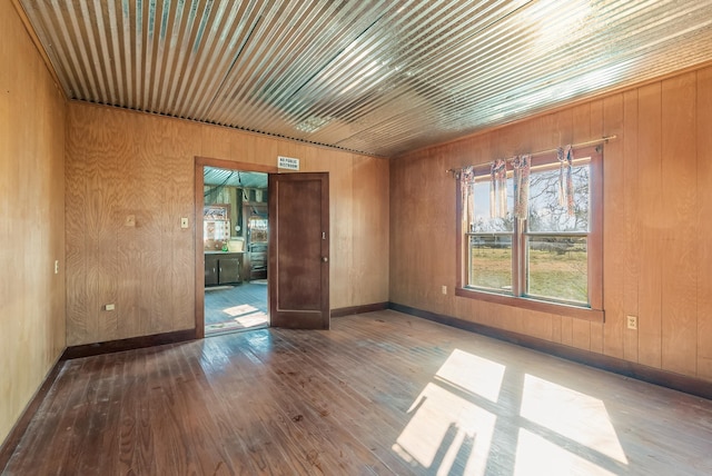 spare room featuring wood ceiling, hardwood / wood-style floors, and wood walls