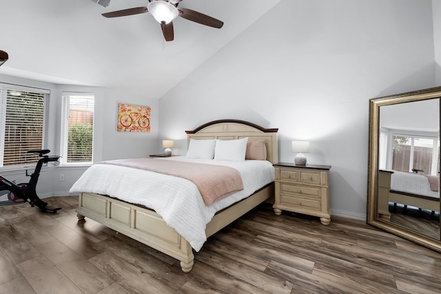 bedroom with dark wood-type flooring, ceiling fan, and vaulted ceiling