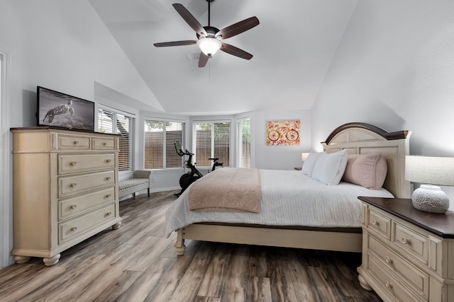 bedroom with wood-type flooring, high vaulted ceiling, and ceiling fan