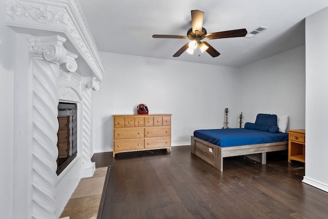 bedroom with ceiling fan and dark hardwood / wood-style flooring