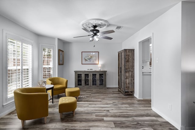 living area with ceiling fan and wood-type flooring