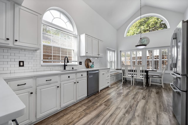 kitchen with white cabinetry, appliances with stainless steel finishes, sink, and decorative backsplash