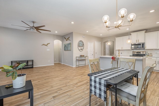 dining room featuring ceiling fan and light hardwood / wood-style flooring