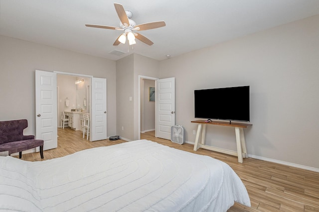 bedroom featuring hardwood / wood-style floors, ceiling fan, and ensuite bathroom