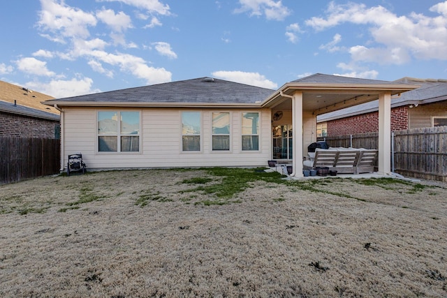 back of property featuring an outdoor hangout area and a patio area