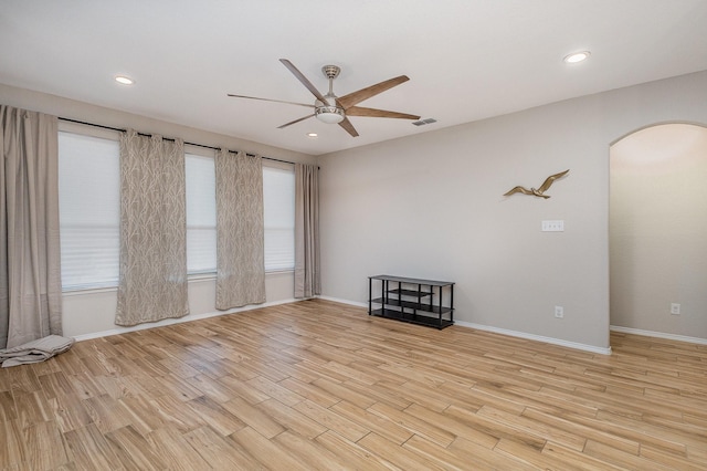 spare room with ceiling fan, plenty of natural light, and light hardwood / wood-style flooring