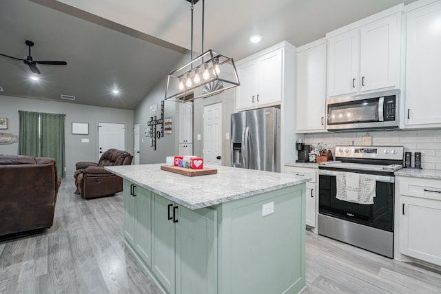 3010 Morris Rd, Mabank, TX 75147 - kitchen with stainless steel appliances, open floor plan, light wood-style floors, white cabinets, and recessed lighting