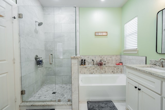 bathroom featuring vanity and separate shower and tub