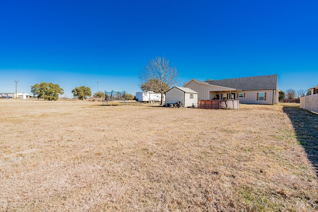 3010 Morris Rd, Mabank, TX 75147 - view of green lawn featuring a trampoline, an outbuilding, and a storage unit