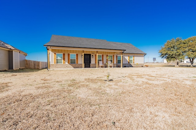 rear view of house featuring covered porch