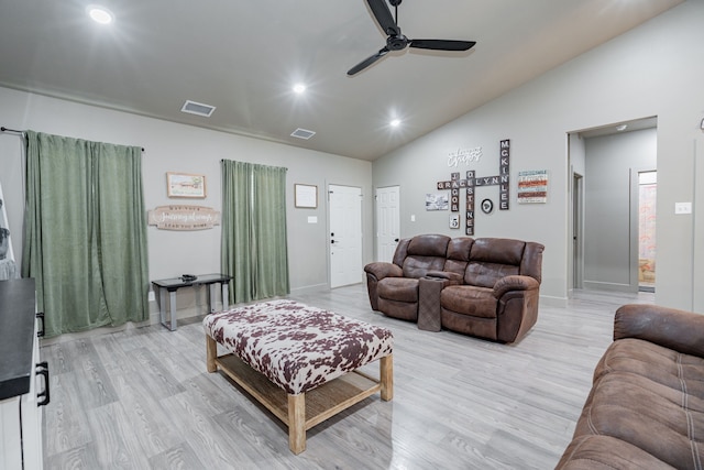 living room featuring ceiling fan, lofted ceiling, and light hardwood / wood-style floors