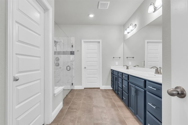 bathroom with tile patterned flooring, vanity, and an enclosed shower