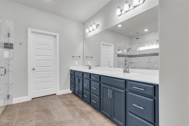 bathroom featuring a shower stall, double vanity, baseboards, and a sink