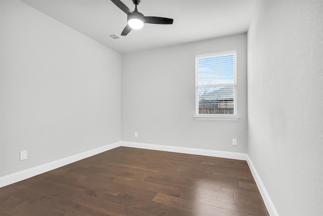 empty room featuring ceiling fan, wood finished floors, visible vents, and baseboards