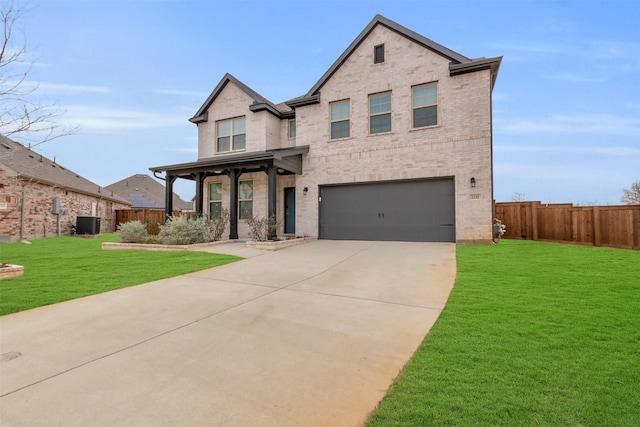 view of front of property with brick siding, an attached garage, a front yard, and fence