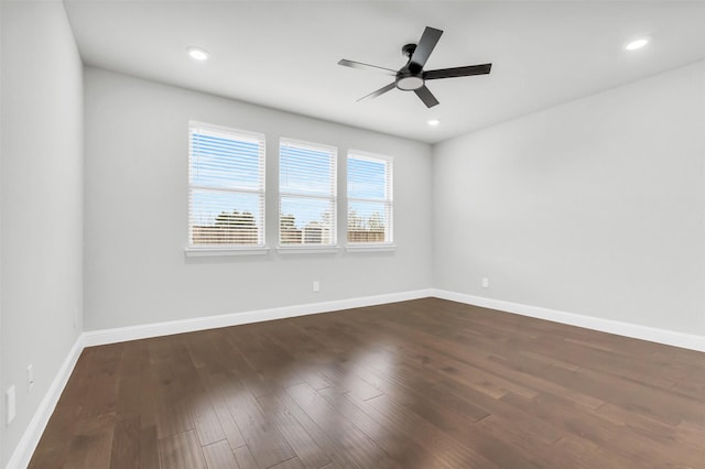 unfurnished room with recessed lighting, a ceiling fan, baseboards, and dark wood-style flooring