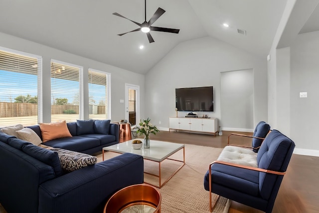 living room with visible vents, high vaulted ceiling, baseboards, and wood finished floors