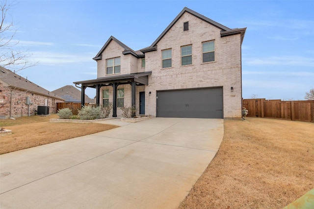 view of front of house with a garage, a front yard, and central air condition unit