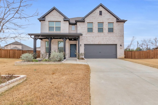 view of front of property with a garage, fence, brick siding, and driveway