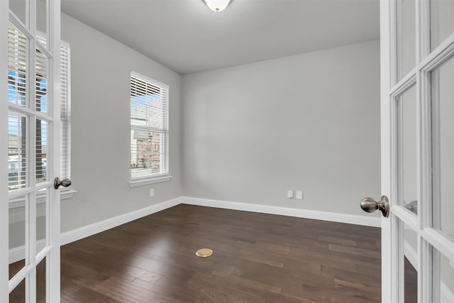 spare room with french doors and dark wood-type flooring