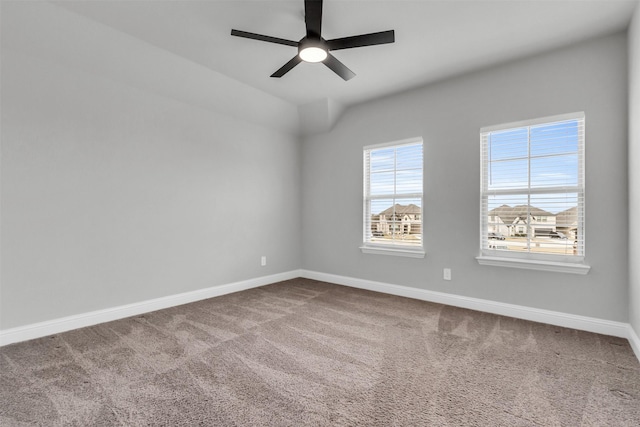 carpeted spare room featuring ceiling fan