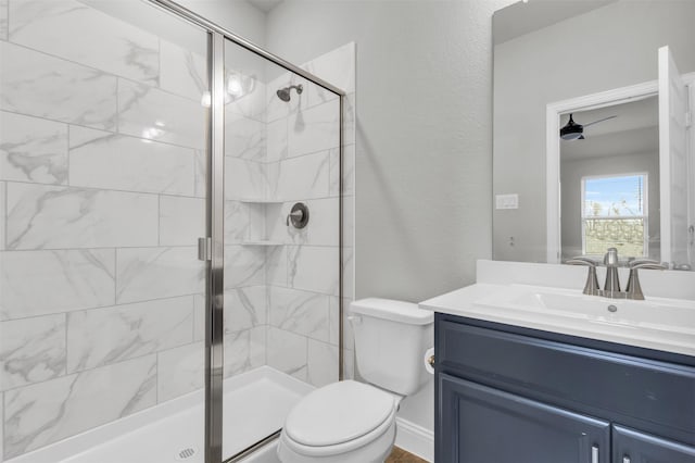 bathroom with vanity, a shower stall, toilet, and a textured wall