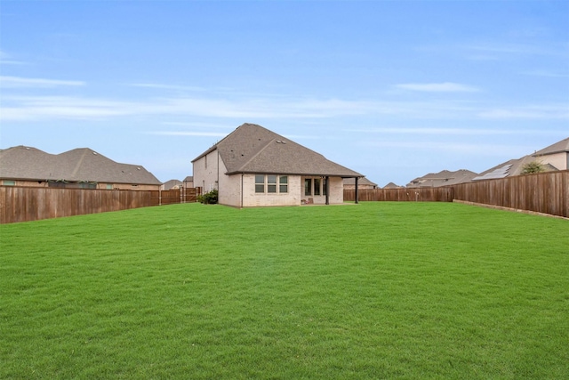 back of house featuring a lawn