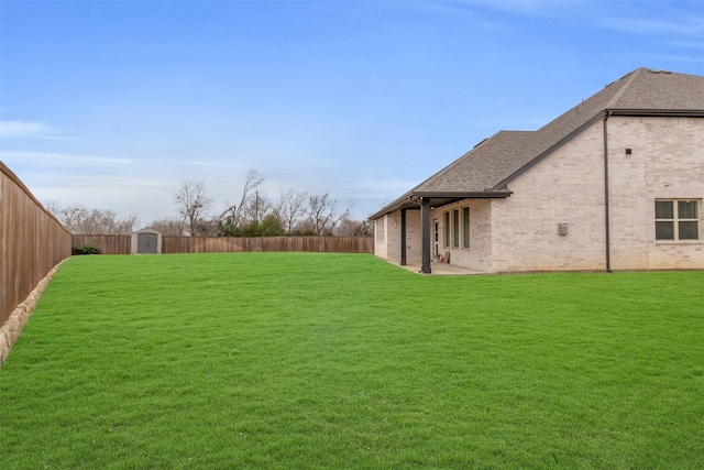 view of yard with a fenced backyard, a shed, an outdoor structure, and a patio