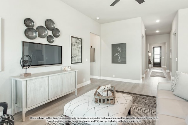 living room with ceiling fan and light hardwood / wood-style floors