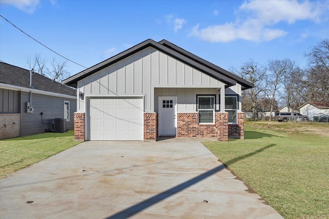 exterior space with a garage, central AC unit, and a front yard