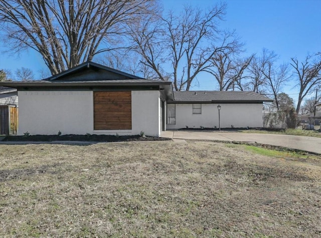 rear view of property featuring a yard