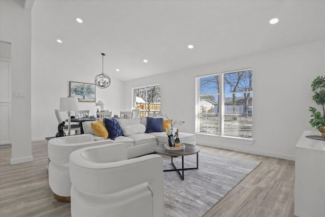 living room with a chandelier and light wood-type flooring