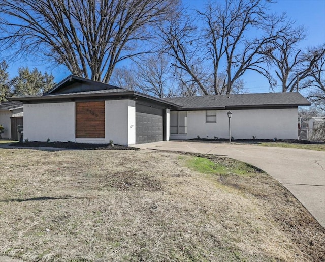 exterior space with a garage and a lawn