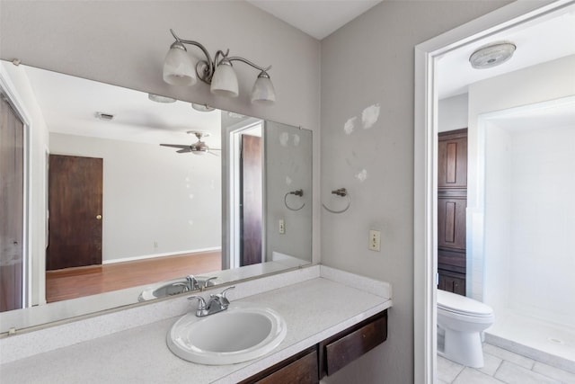 bathroom featuring visible vents, toilet, a stall shower, ceiling fan, and vanity