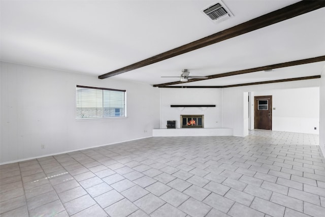 unfurnished living room featuring light tile patterned floors, visible vents, a ceiling fan, a fireplace, and beam ceiling