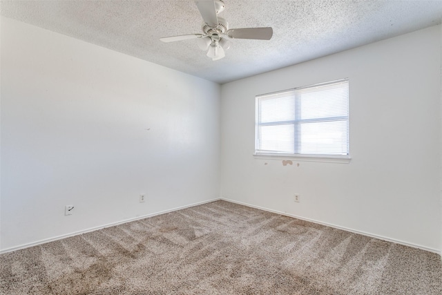 carpeted spare room with ceiling fan and a textured ceiling