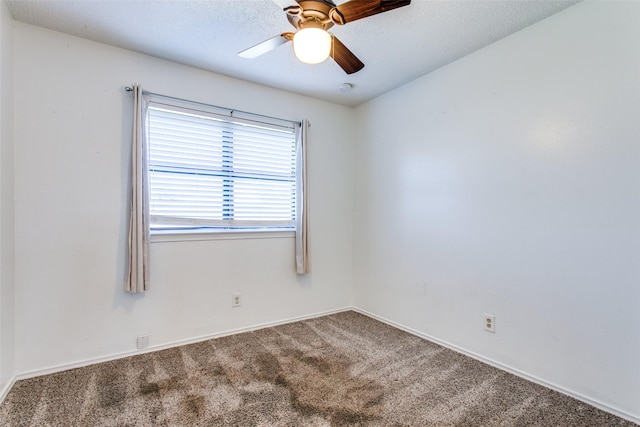 empty room with ceiling fan and carpet floors