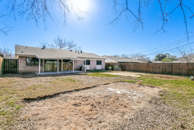 rear view of property with a patio area and a lawn