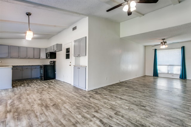 kitchen with gray cabinetry, range, pendant lighting, light hardwood / wood-style floors, and backsplash