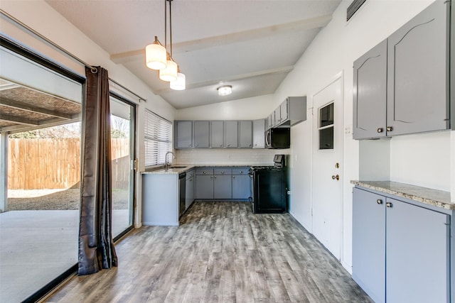 kitchen featuring sink, gray cabinetry, hanging light fixtures, stainless steel appliances, and decorative backsplash